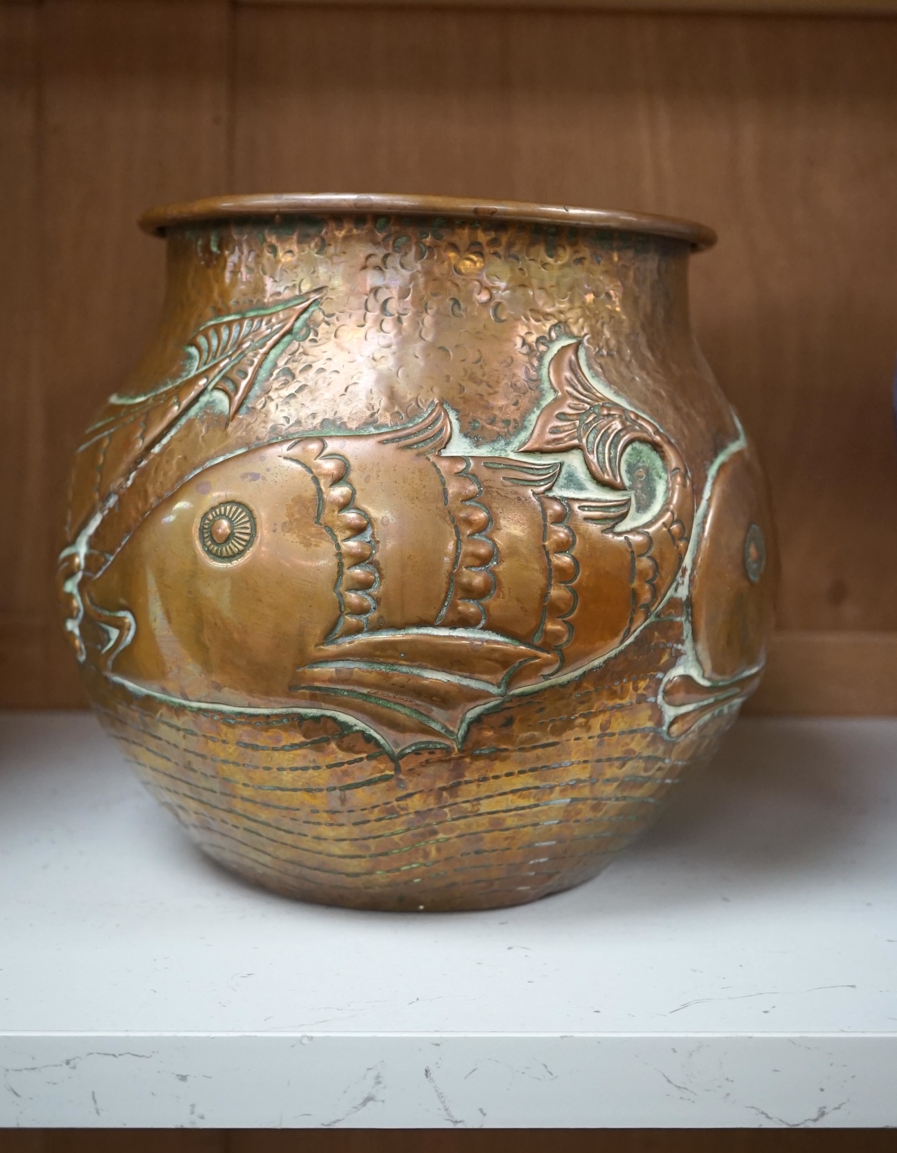 A Newlyn Arts & Crafts jardiniere by John Pearson, decorated with four different fish, signed and numbered 2473. Condition - minor dents, essentially good